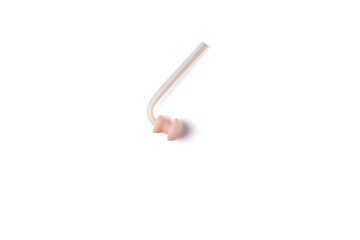 Hearing aid replacement eartip dome with silicone tube isolated on white background. Hearing aid accessories. Top view