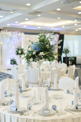 Beautiful setting of the wedding banquet table in the restaurant with the name of the guest.
