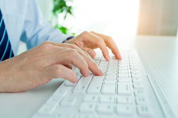Male office worker typing on the keyboard