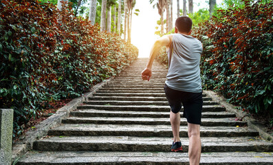 Rear view of young man running on stairs