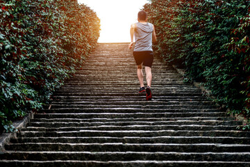 Rear view of young man running on stairs