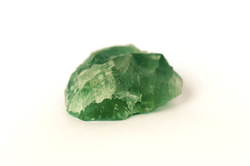 macro shooting raw gemstone of green fluorite rock isolated on white background.