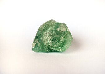 Macro shooting raw green fluorite stone rock isolated on white background.