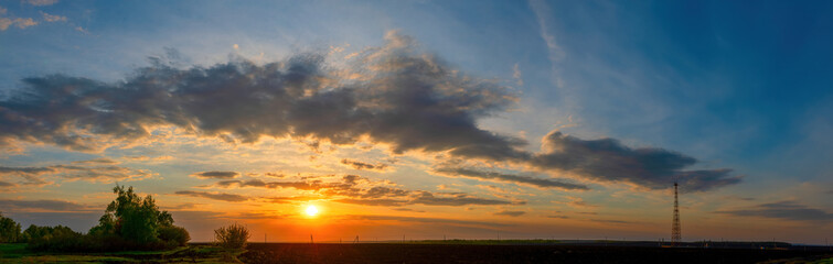 Natural Sunset Sunrise Over Field Or Meadow. Bright Dramatic Sky Over Countryside Landscape Under Scenic Sky At Sunset Dawn Sunrise. Skyline, Horizon
