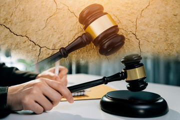 justice and law concept.Male judge in a courtroom on wooden table and Counselor or Male lawyer...