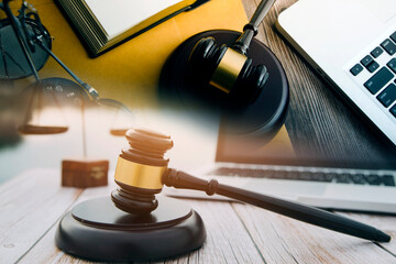 justice and law concept.Male judge in a courtroom on wooden table and Counselor or Male lawyer working in office. Legal law, advice and justice concept.