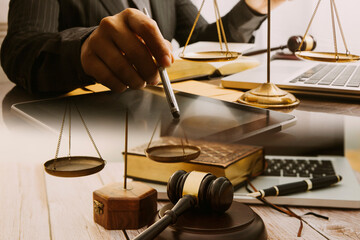 Business and lawyers discussing contract papers with brass scale on desk in office. Law, legal...