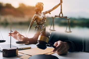 justice and law concept.Male judge in a courtroom on wooden table and Counselor or Male lawyer working in office. Legal law, advice and justice concept. - obrazy, fototapety, plakaty