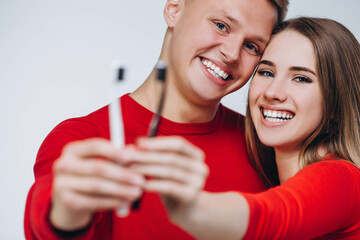 A couple of people is holding out their toothbrush.
