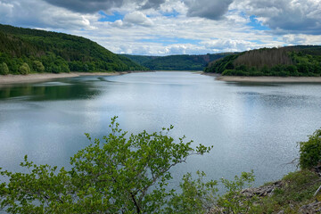 Scenic view of Urft Reservoir at Nationalpark Eifel in Germany with low water level .