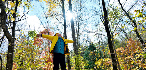 Funny happy child in autumn forest