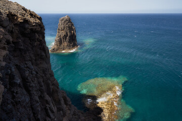Seascape with big rock and cliff