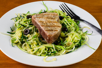 tuna  steak with zucchini noodles and black olives