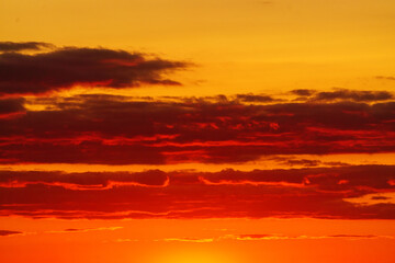 Colorful sunset in the evening sky. Great dramatic view. Clouds illuminated by the setting sun. Amazing sky panorama. Meditative calmness and greatness. Mystical lighting