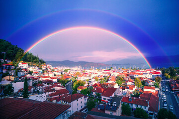 Port town in rainy weather. An amazing atmospheric phenomenon is a circular rainbow. Beautiful...