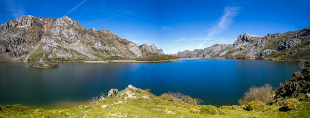 Fototapeta na wymiar Panoramic view of Lago del Valle in Asturias, Spain. Its waters are crystal clear and reflect the mountains that surround it. Nature in all its splendor.