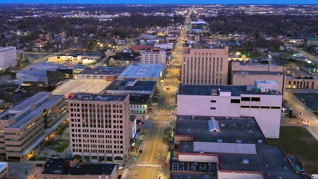 Appleton Wisconsin's College Avenue with city lights at night, aerial view.
