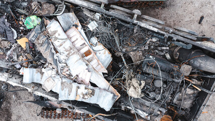 The war in Ukraine, the Russian MTLB exploded, military equipment near Irpin, Kyiv region, was destroyed. Vertical view from a drone, aerial photography