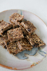 plate with cut up homemade date and oat granola bars on ceramic plate