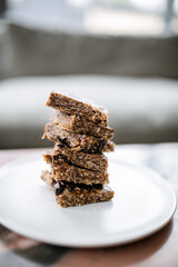Stack of homemade no-bake date and oat granola bars with chocolate chunks