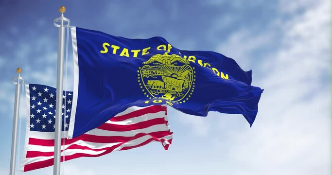 Seamless loop of the Oregon state flag waving along with the national flag of the United States of America