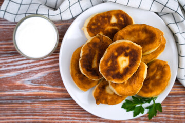 Crispy hot fried pies with meat and potatoes on a wooden table. Top view. Close-up. Place for text.