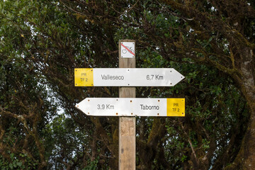 Tourist signs showing direction and distances of two popular hiking routes in the Anaga mountain range, from the viewpoint Pico del Ingles, Tenerife, Canary Islands, Spain