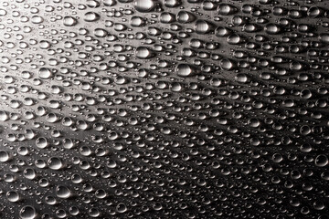 Abstract background with drops of water on metal flat surface