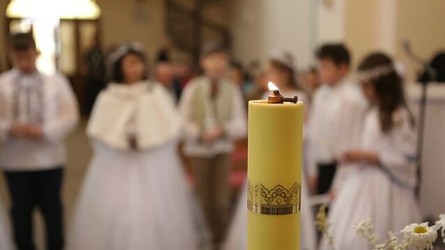 Children stand in church for their first communion, blurry image.Children go to confession and receive the Eucharist for the first time.