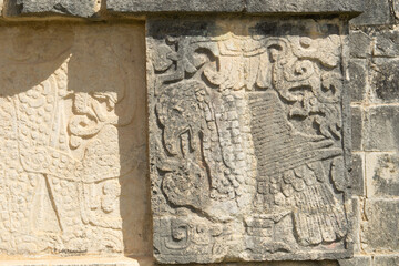 Closeup view of details on the platform of the Eagles and Jaguars in the Mayan ruins in the Great Plaza in the Chichen Itza, Mexico. Engraving depicted on the platform for sacrifices.