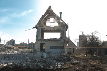 Destroyed civilian house. Ruins of a destroyed house. Demolition of the old house. Destroyed walls and windows of the building.