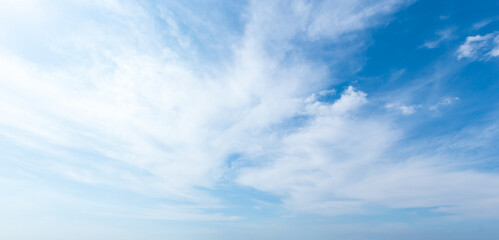 blue sky background with white clouds cumulus floating soft focus.