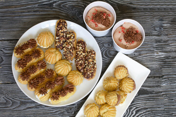 Homemade eclairs with cream. They lie on a plate. Custard pastries with cream. Close-up.