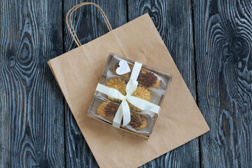 Homemade eclairs with cream. They lie on a plate. Custard pastries with cream. In a gift box. Close-up.