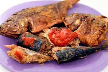 Sea food cuisine of various fishes, fried Nile tilapia fishes Oreochromis Niloticus fried in deep...