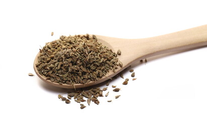 Anise seeds spice (Pimpinella anisum) in wooden spoon isolated on white