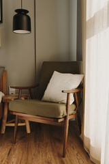 Fototapeta na wymiar Aesthetic elegant modern stylish bedroom interior design concept. Cozy neutral Scandinavian comfortable living room with furniture, hanging lamp, armchair. Sunlight shadows