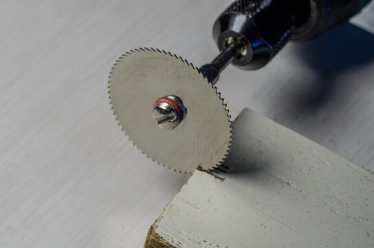 The Master Cuts A Wooden Plank With An Engraver