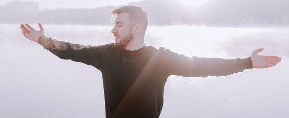 Fit strong healthy and inspired man in the morning covered by sunrise.