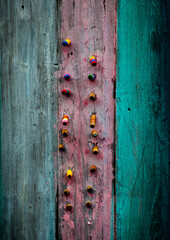 grunge abstract background of colour wood panels with pins on it 
