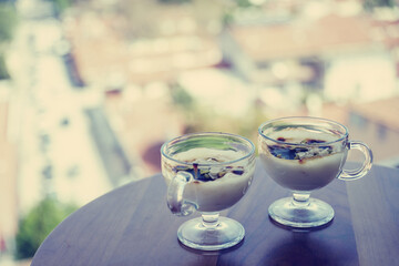 Delicious treat from Turkey. Sweetness for breakfast on the background of the seaside city. Traditional Turkish pudding. A postcard from Turkey