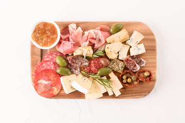 Traditional Italian antipasti board with variety of cheeses, sausages served with sun dried...