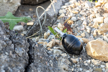 a military grenade lying among the rubble and ruins