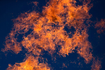 Gas burning, fire flame on sky in the background