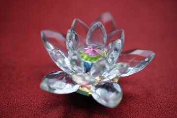 Crystal lotus on red table. Muladhara chakra symbol