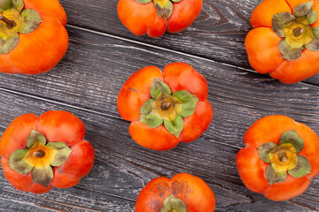 persimmon on wood background top view