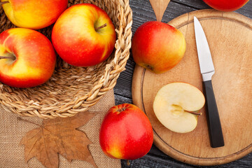 sliced colorful apple on wood background top view