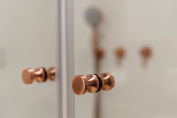 Closeup shot of bronze colored shower handles