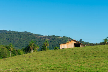 Fototapeta na wymiar A wooden barn in the countryside of Tres Coroas - Rio Grande do Sul state, Brazil