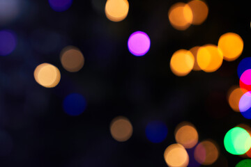 Black background of blurred bokeh with warm colorful lights. With space to copy. High quality photo